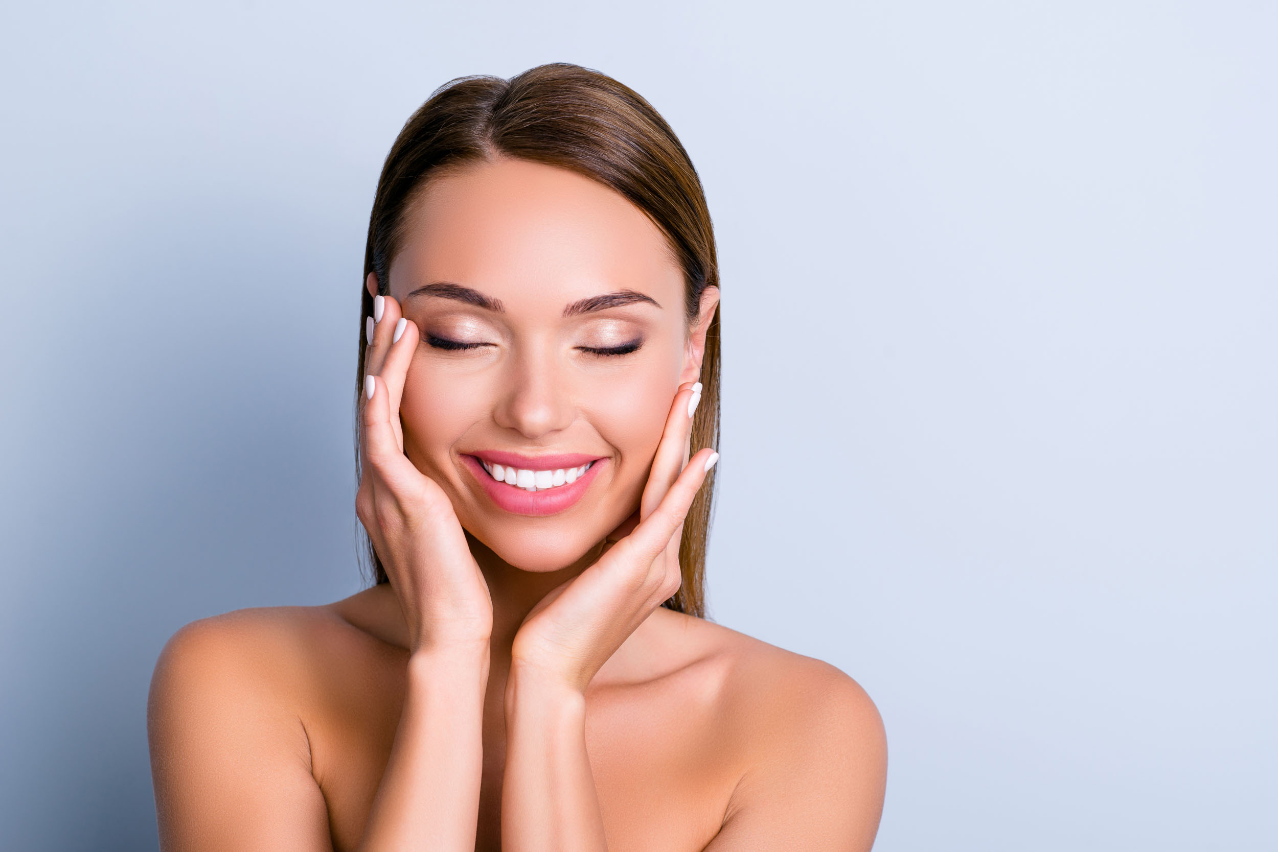 Portrait of pleased satisfied girl touching face representing botox treatments