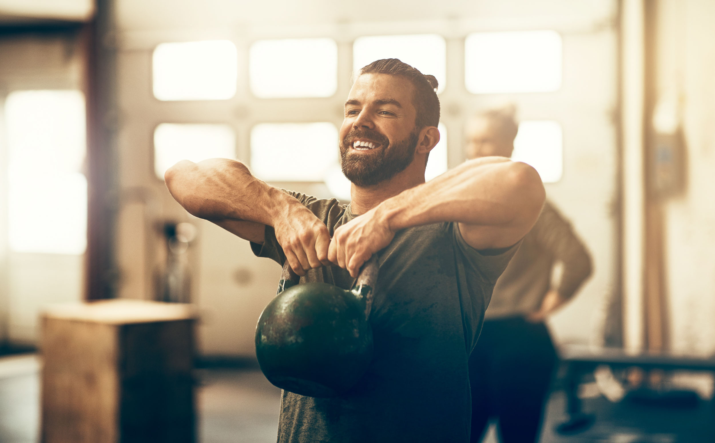 Fit young man in sportswear smiling and working out representing treatments for men