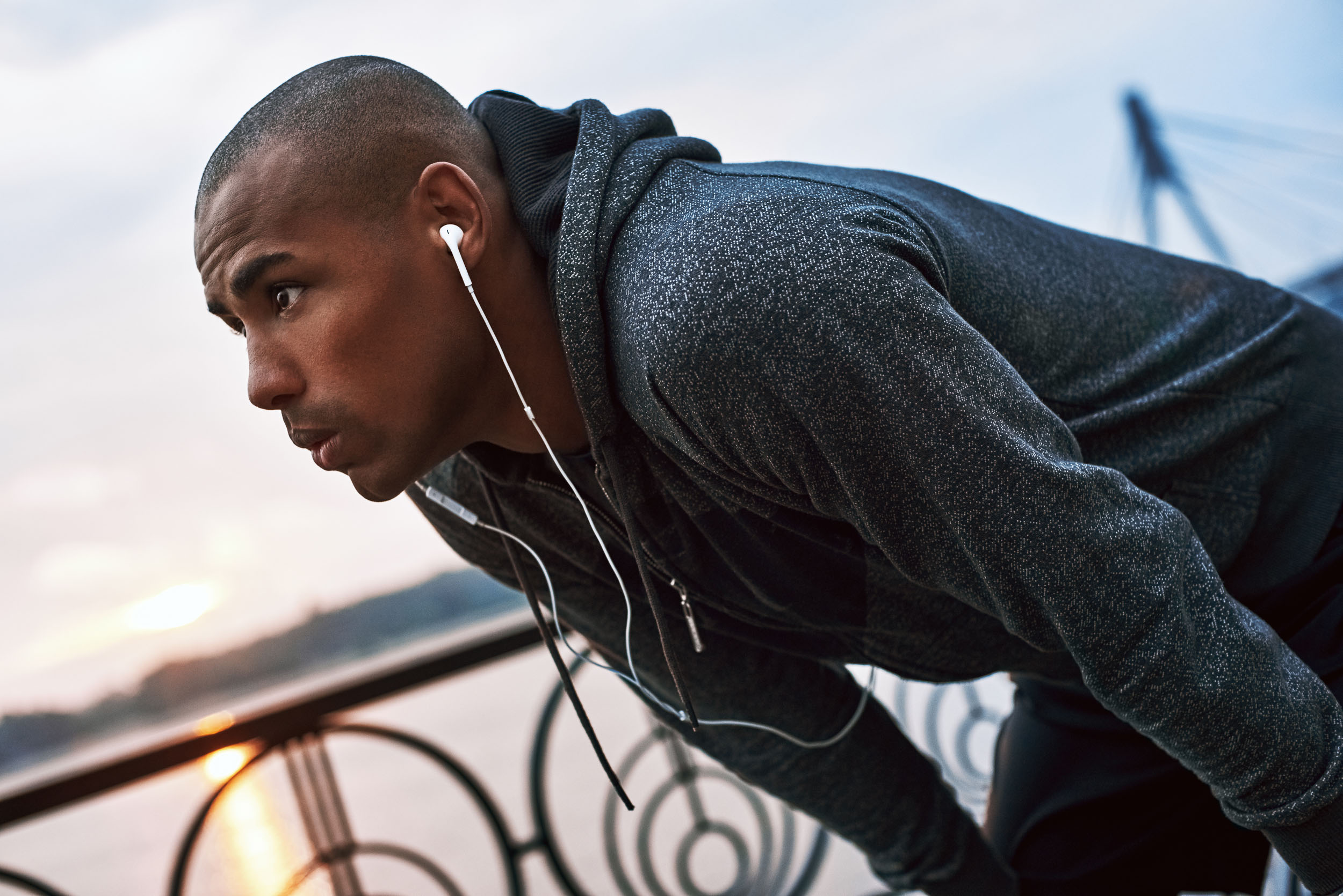 Young jogger is stopped to catch his breath – representing treatments for men.